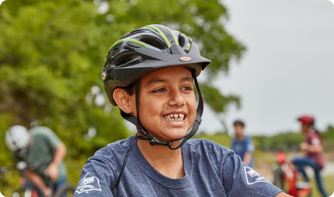 Cub Scout Boy Smiling wearing bike helmet